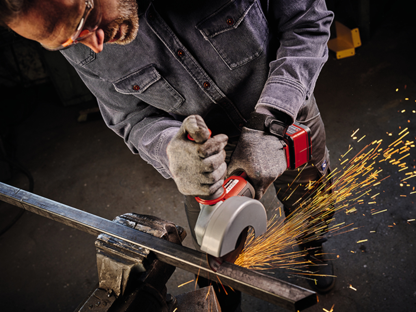 man cuts iron and sparks fly